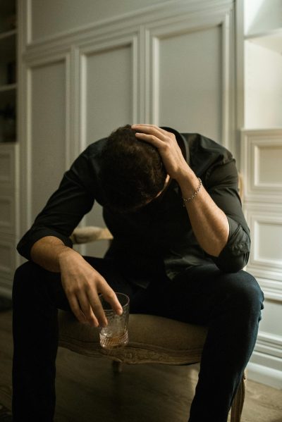 Man with black dress Man with depression holding a glass of alcohol.